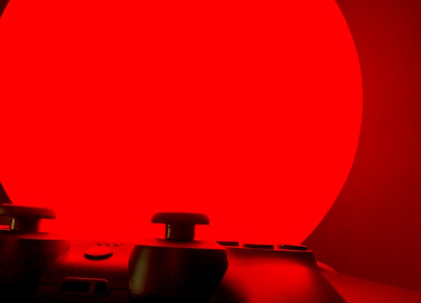A caution sign with a game controller illustration signaling responsible gaming.