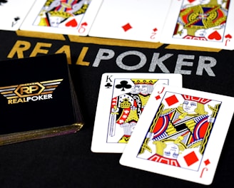 A vibrant rummy game interface showing cards and player scores with bright gradient backgrounds.