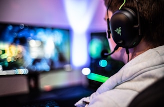 A friendly support agent wearing a headset, smiling and ready to assist gamers.